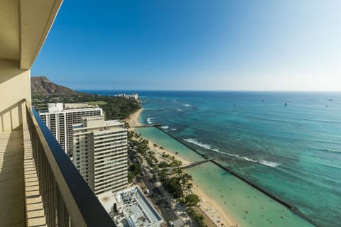 Sweeping ocean views stretch from Diamond Head to the sparkling turquoise waters, with Waikiki Beach unfolding below beneath swaying palms and golden sands.