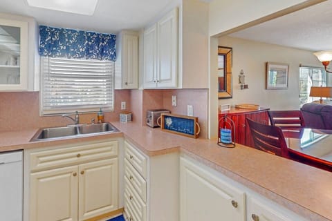 Clean kitchen with all the necessary appliances and a pass thru to the indoor dining area.