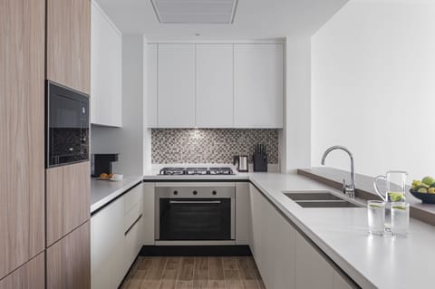 Deluxe Suite, 2 Bedrooms, Balcony | Private kitchen | Fridge, microwave, oven, stovetop