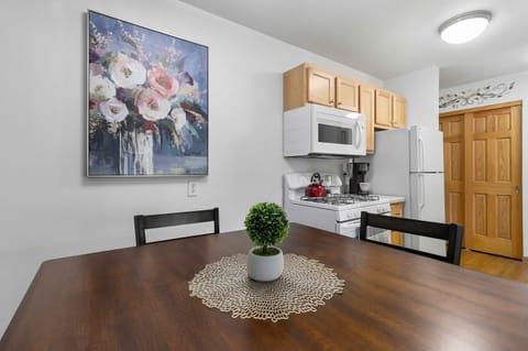 Full size dining table and plenty of storage space in kitchen cabinets.