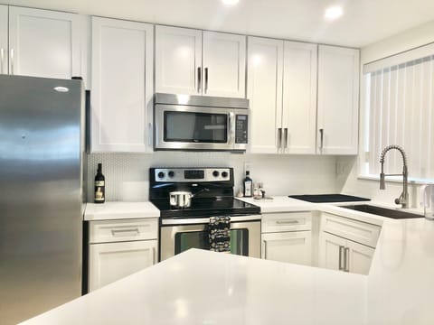 New white updated kitchen with quartz counter tops Great Lighting