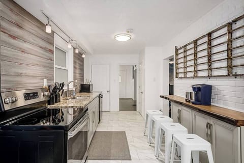 Your open kitchen includes granite countertops, SS appliances, and a Keurig