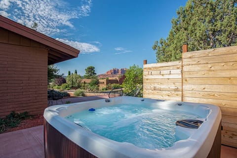Relax in the hot tub while taking in the red rock view