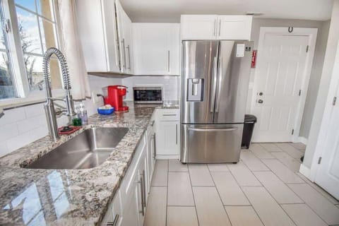 Modern appliances, cookware, and a dining area for home-cooked meals.