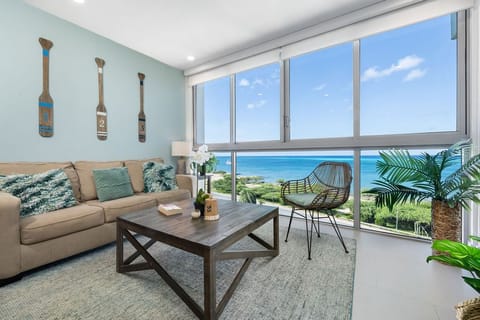 Sink into the plush sofa and gaze out at breathtaking ocean views framed by floor-to-ceiling windows. Your coastal retreat awaits with coastal-themed decor and modern comforts.