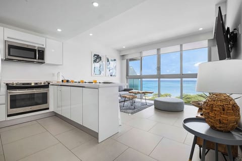Wake up to stunning ocean views from your modern kitchen and living space, where soft breezes and turquoise waters create your perfect tropical backdrop.