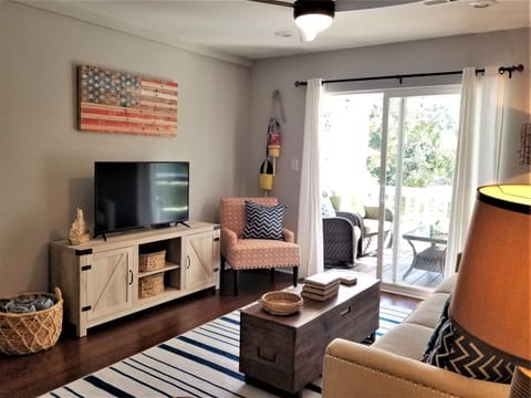 Comfortable, stylish living area with TV and curated art & furniture