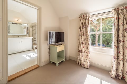 First floor: Master bedroom with television and en-suite bathroom