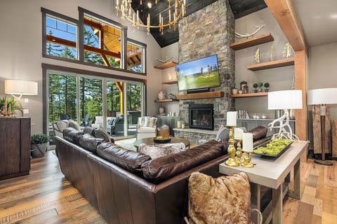 Great Room – Entry Lounge with Designer Lighting, Gas Fireplace, and Oversized Gathering Sofa.