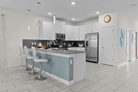 Your spacious kitchen features modern appliances and a welcoming breakfast bar where you'll start each morning with coffee.
