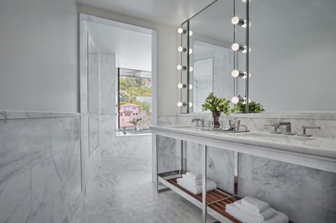 Shower, designer toiletries, hair dryer, bathrobes