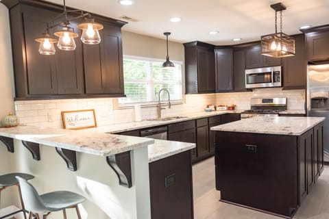 Spacious kitchen with dishwasher, stove, built-in microwave and full size fridge