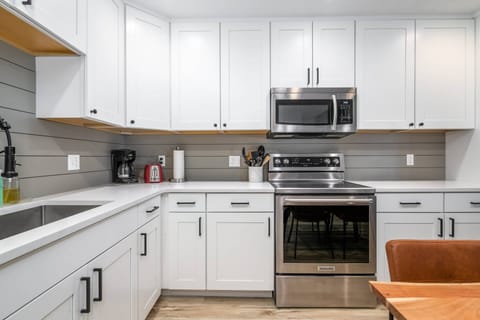 A fully equipped kitchen just steps away from the dining table.