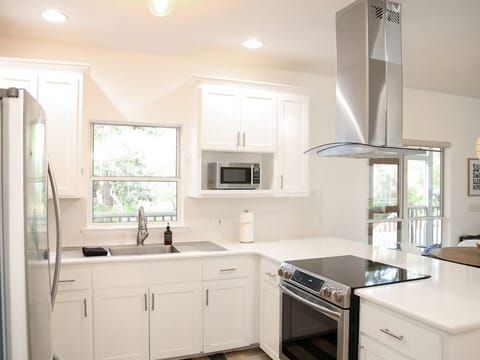 - Cook like a pro in this modern kitchen stocked with all the essentials - Savor the view while you prep, with natural light pouring in through the window - Whether it’s breakfast or a late night bite, you’ll love the sleek appliances and open, airy