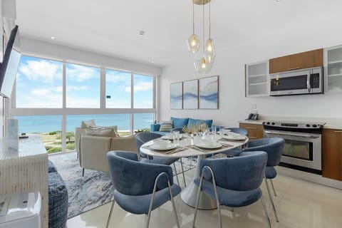 Sip your morning coffee at this sleek dining table for six, where floor-to-ceiling windows frame stunning ocean views just steps away from your private beach access.