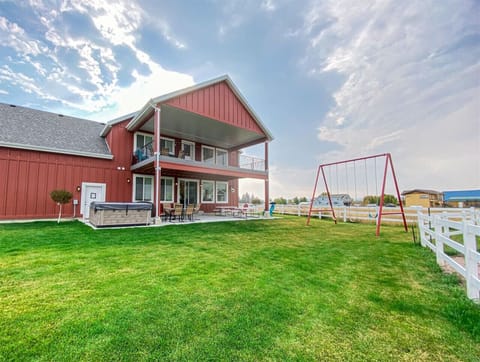 Fun backyard escape with swings, hot tub, and plenty of space for fun and relaxation.
