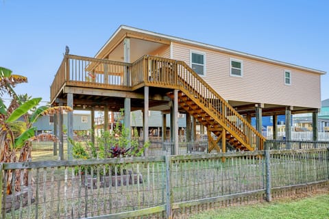 Elevated home with wrap-around deck and fenced yard
