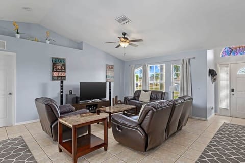 Premium sound system, smart TV, and vaulted ceilings characterize the living room