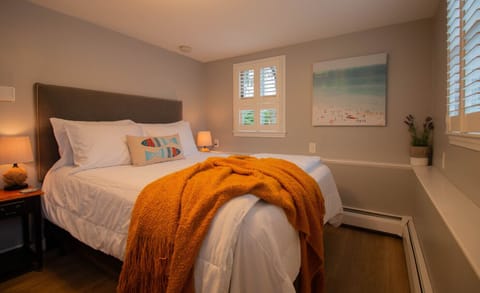 Comfortable queen bed with plush bedding, cozy linens, and plenty of pillows.