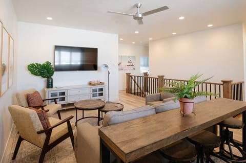 Bright upstairs living room with comfortable seating, large TV, cozy sectional, and open loft-style layout. This additional space is perfect for relaxing after a day of exploring.