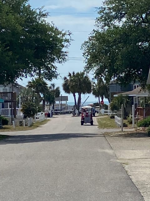 The main road going into the gated beach access. Home is in culdesac to the left
