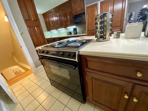 Stovetop and Oven - Stairs Leading to the Downstairs Master