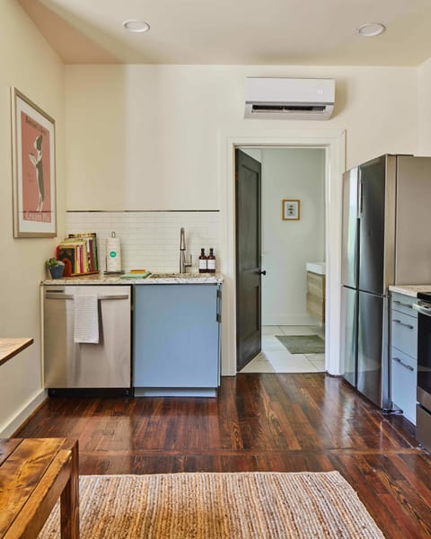 Across the kitchen, you will find the door to the bathroom.