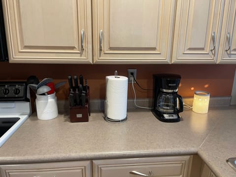 Sharp knives, utensils, paper towel and coffee maker provided
