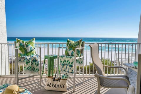 Unwind on your private oceanfront balcony with tropical-themed seating while endless waves roll over the shore.