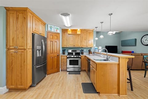 Double kitchen: stove, oven, warming drawer, pantry, dishwasher, and fridge.