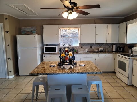 Open spacious kitchen with plenty of cabinet space and center island for seating