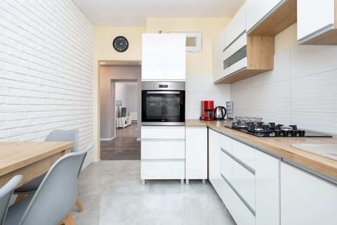 Kitchen with plenty of kitchen utensils and dishes. 