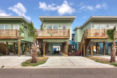Colorful beach houses with elevated design and tropical palm trees create a vibrant coastal neighborhood perfect for a seaside getaway.