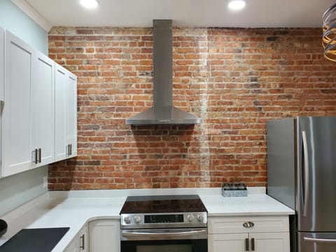 Original brick feature wall in the kitchen and bathroom