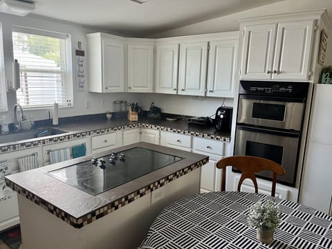 Kitchen with plenty of cabinets and island stove top
