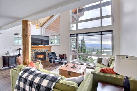 Living space with soaring two storey windows with panoramic views.