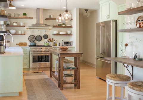 Kitchen has a custom island for prep, with seating