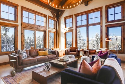 Main floor living room with mountain views and wood burning fireplace