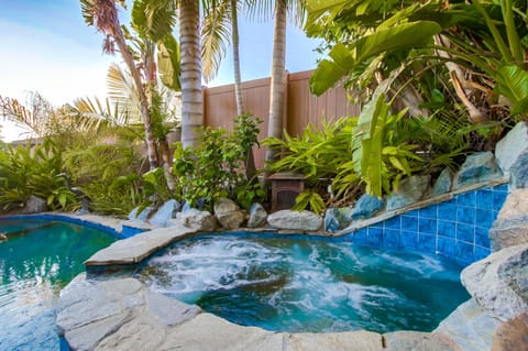 Unwind in your private backyard oasis, where the soothing spa, lush palms, and tranquil ambiance invite pure relaxation.