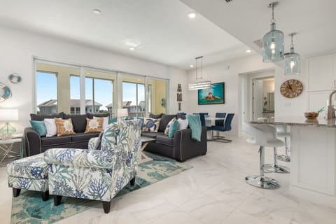 Brand new, open, spacious and comfortable living area offering plenty of seating and a 65" smart TV.  A wall of sliding doors open the space to the private lanai.