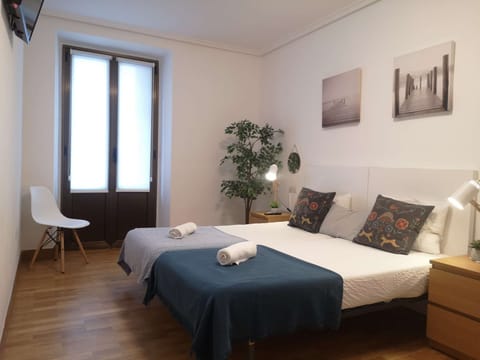 Twin bedroom with balcony and TV