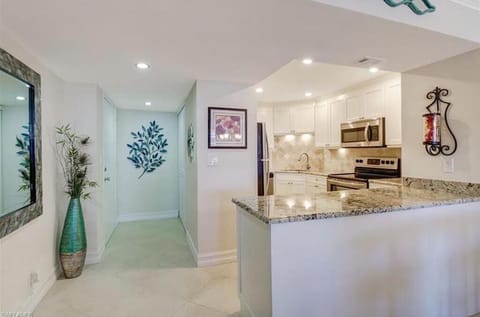 Entry door to the left, kitchen to the right
