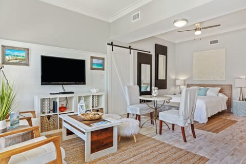 Cozy 30A studio with a queen bed, sleeper sofa, and coastal décor—just a short walk to the beach. Bright, open layout with TV, dining area, and beachy charm throughout.