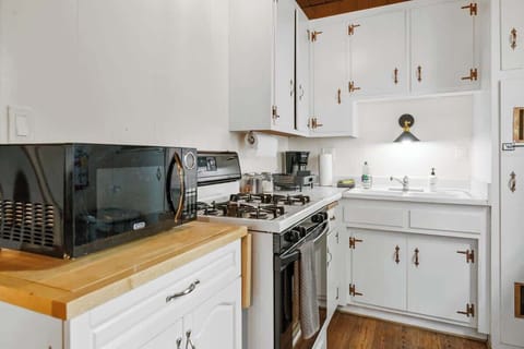 Kitchen- Microwave, gas stove, full sized fridge. drip coffee maker