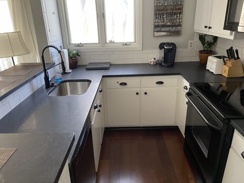 New honed black granite countertops with a white subway tile backsplash