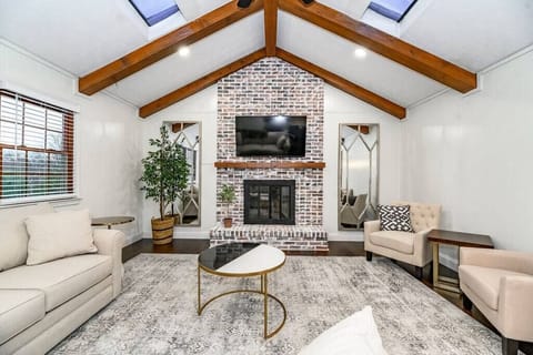Gather in the inviting family room, featuring cozy seating, a large Smart TV, and a warm, relaxing ambiance, perfect for movie nights, board games, or simply spending quality time together.