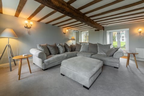 Barn Cottage, Salthouse: Sitting room with beams, stunning views of the marshes to the front and double doors to the rear garden