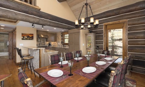 Gather around this rustic dining table where warm wood beams and cozy mountain charm create the perfect setting for your memorable meals together.