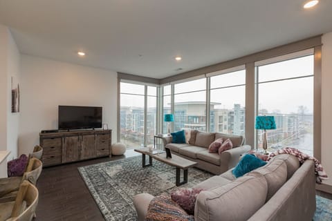 Living room area with open windows that look out to the Melrose/8th Ave neighborhood!