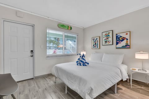 Sleeping Area: Features a plush King-sized bed shared with the main living space.